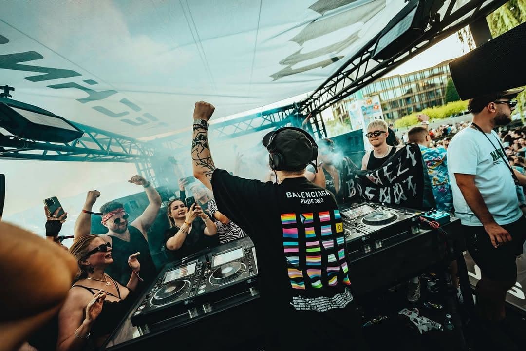 Klangkuenstler performing at Technoabteil Festival in Switzerland with crowd dancing at outdoor hard techno stage