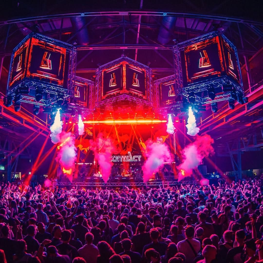 Contact Festival Munich 2025 main stage with a huge crowd, immersive lighting, smoke effects, and LED cubes during a techno performance.